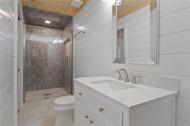bathroom with marble finish floor, toilet, vanity, and a stall shower
