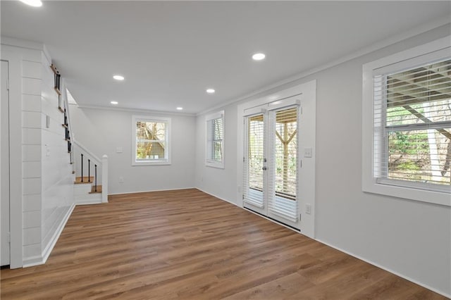 entryway featuring stairs, crown molding, wood finished floors, and recessed lighting