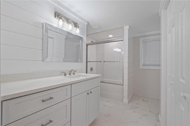 bathroom featuring marble finish floor, baseboards, vanity, and shower / bath combination with glass door