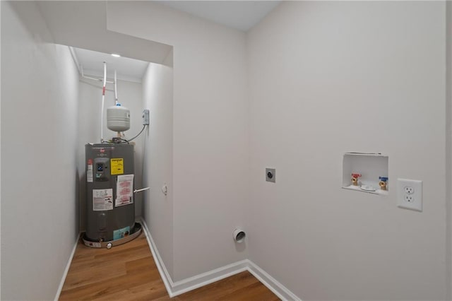 laundry area featuring wood finished floors, hookup for an electric dryer, hookup for a washing machine, baseboards, and electric water heater