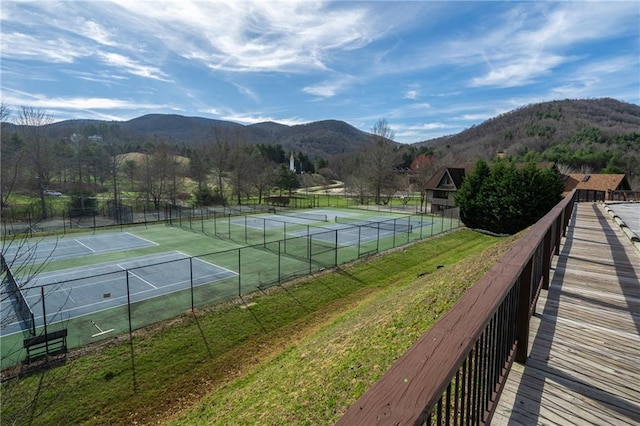 view of sport court featuring a mountain view and fence