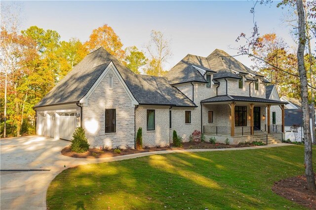 view of front of home with a garage and a front lawn