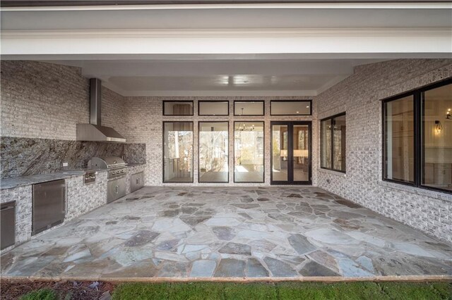 foyer featuring french doors, light hardwood / wood-style floors, and crown molding