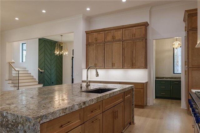 kitchen featuring high quality appliances, pendant lighting, beverage cooler, and sink