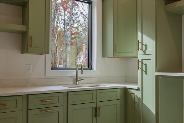 kitchen with green cabinets and sink