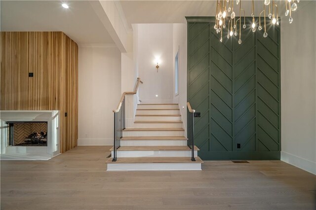 interior space with wood walls, french doors, light hardwood / wood-style flooring, and a chandelier