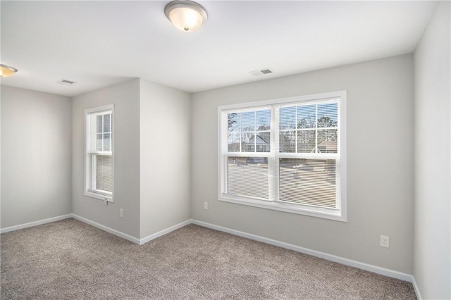 spare room featuring light colored carpet