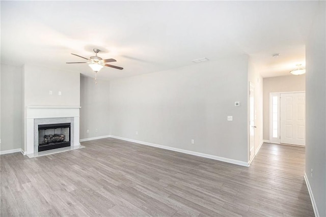 unfurnished living room with hardwood / wood-style floors and ceiling fan