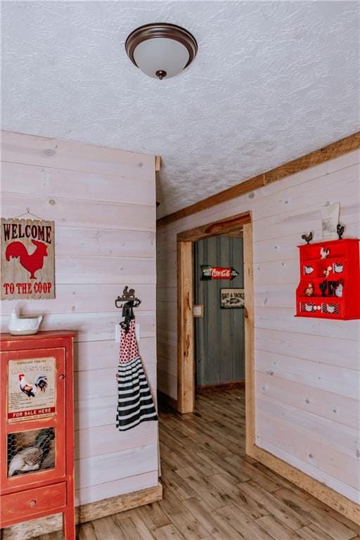 4625 Ben Hill Dr, Oakwood, GA 30566 - hall with a textured ceiling, wood walls, and wood finished floors