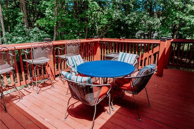 4625 Ben Hill Dr, Oakwood, GA 30566 - deck featuring outdoor dining space and view of wooded area