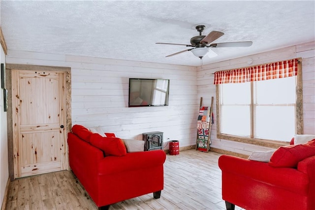4625 Ben Hill Dr, Oakwood, GA 30566 - living area featuring wood finished floors, ceiling fan, a textured ceiling, and wood walls
