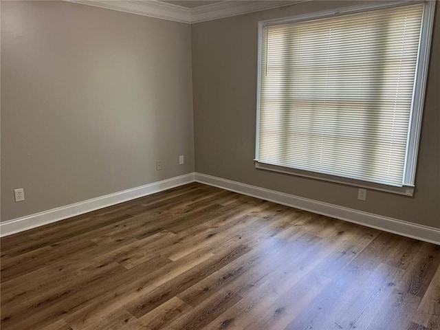 unfurnished room with crown molding and dark wood-type flooring