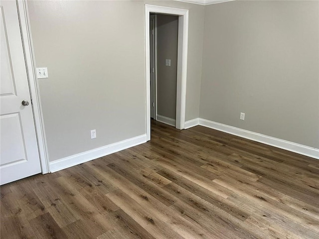 spare room featuring dark wood-type flooring