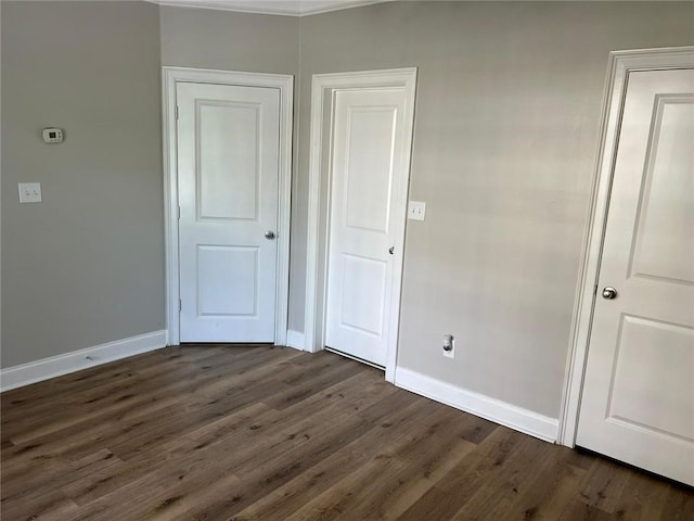 unfurnished bedroom featuring dark wood-type flooring