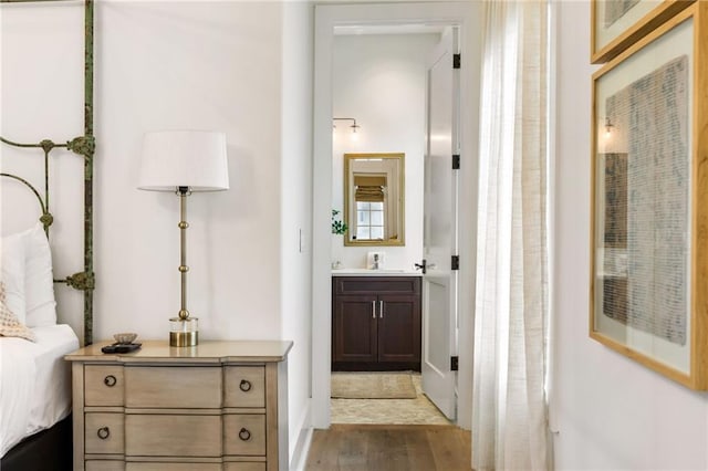 hallway featuring a sink and wood finished floors