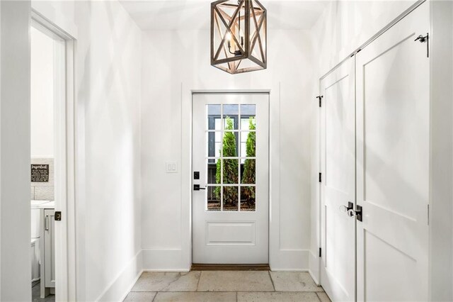 doorway to outside with baseboards