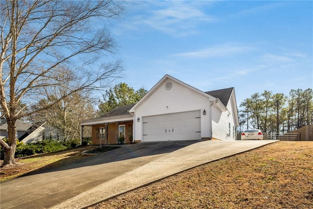 ranch-style house featuring a garage and concrete driveway