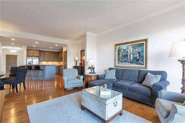 living room with hardwood / wood-style flooring and ornamental molding