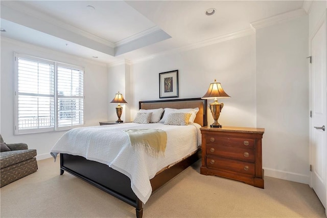 bedroom featuring light carpet, a tray ceiling, and ornamental molding