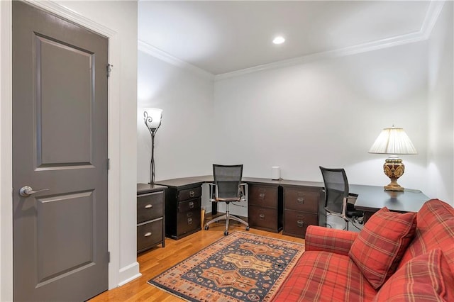 office space with light wood-type flooring and crown molding