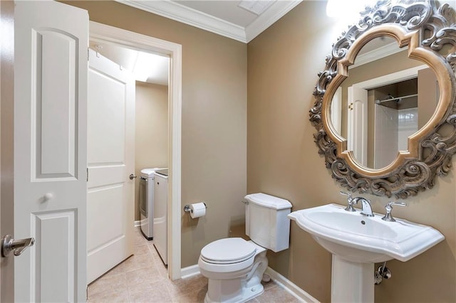 bathroom featuring crown molding, toilet, tile patterned floors, and washing machine and clothes dryer