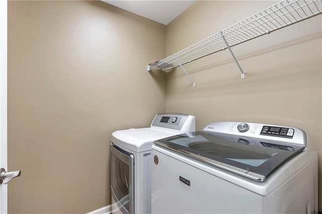 clothes washing area featuring washing machine and clothes dryer