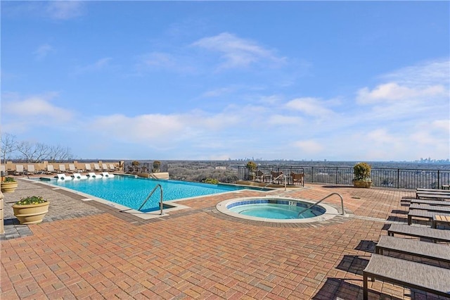 view of pool with a patio and a hot tub