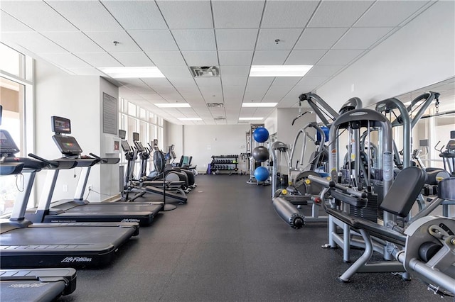 exercise room featuring a drop ceiling