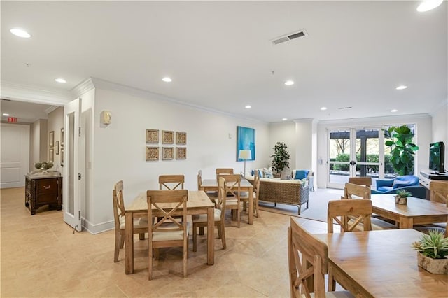 dining area with ornamental molding and french doors