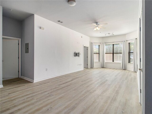 unfurnished living room featuring ceiling fan and light hardwood / wood-style floors