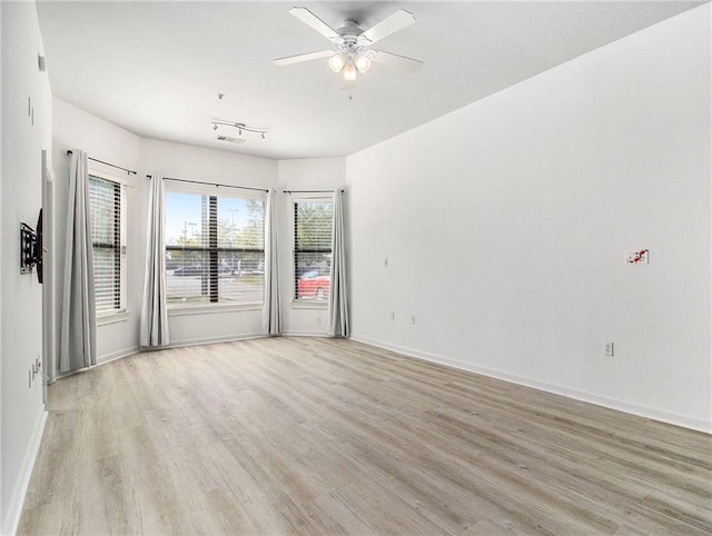 unfurnished room featuring ceiling fan and light hardwood / wood-style flooring