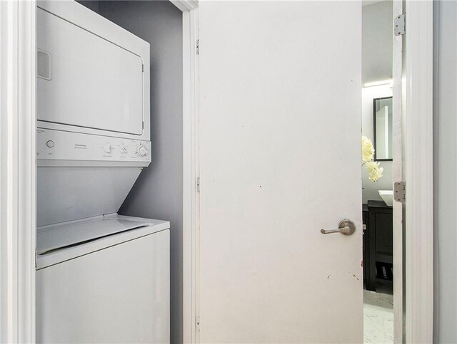 laundry area with stacked washer / drying machine