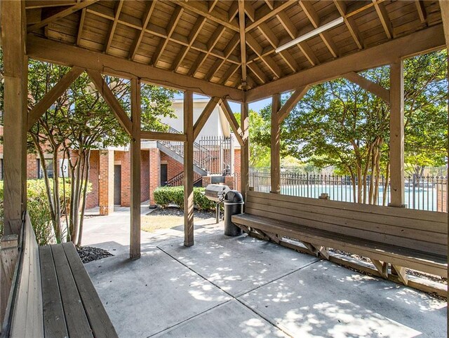 view of patio with a gazebo and a water view