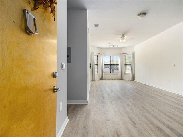 unfurnished living room with ceiling fan and light hardwood / wood-style floors