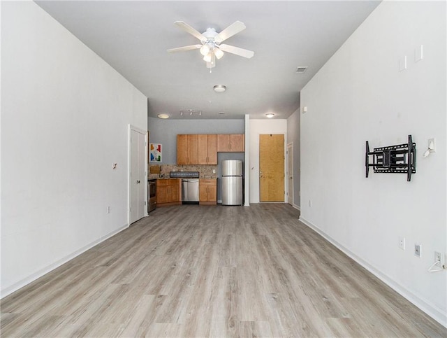 unfurnished living room with ceiling fan and light hardwood / wood-style floors