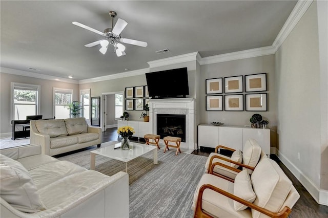 3925 Sierra Knolls Ct, Cumming, GA 30040 - living room featuring wood finished floors, baseboards, crown molding, a ceiling fan, and a high end fireplace