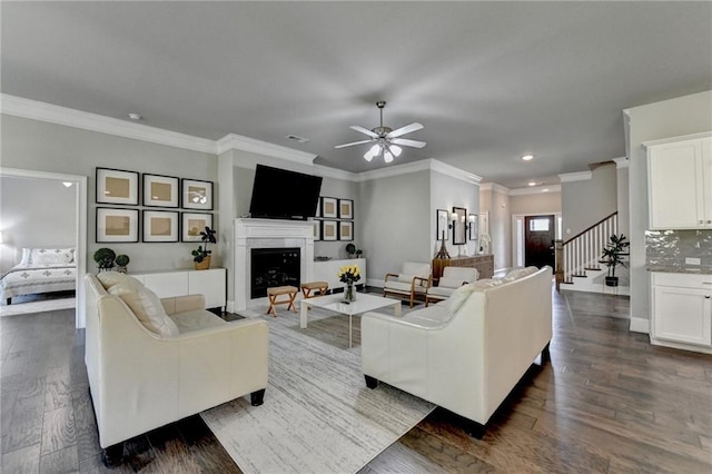 3925 Sierra Knolls Ct, Cumming, GA 30040 - living area with a ceiling fan, crown molding, stairway, a fireplace, and dark wood-style floors