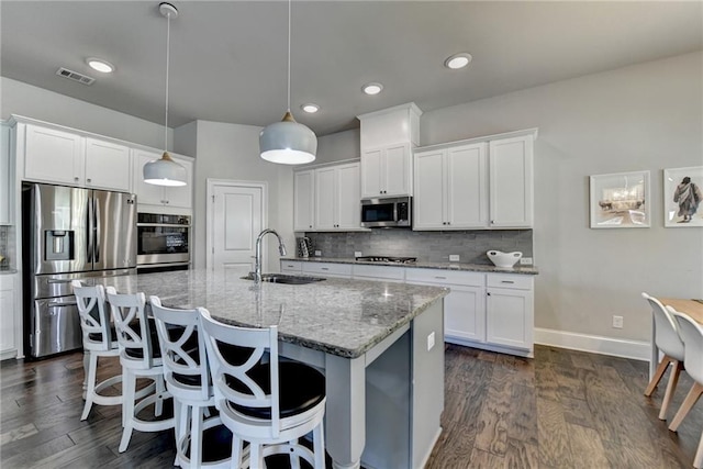 3925 Sierra Knolls Ct, Cumming, GA 30040 - kitchen with a sink, stainless steel appliances, backsplash, white cabinetry, and a breakfast bar area