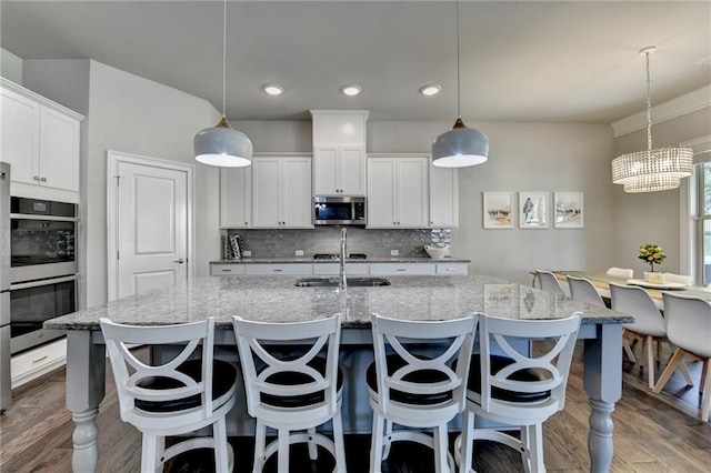 3925 Sierra Knolls Ct, Cumming, GA 30040 - kitchen featuring stainless steel appliances, tasteful backsplash, wood finished floors, white cabinets, and recessed lighting