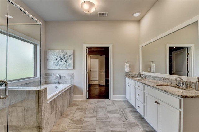 3925 Sierra Knolls Ct, Cumming, GA 30040 - bathroom featuring a bath, double vanity, and baseboards