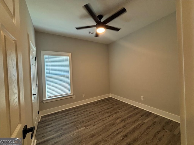 unfurnished room featuring ceiling fan and dark hardwood / wood-style floors