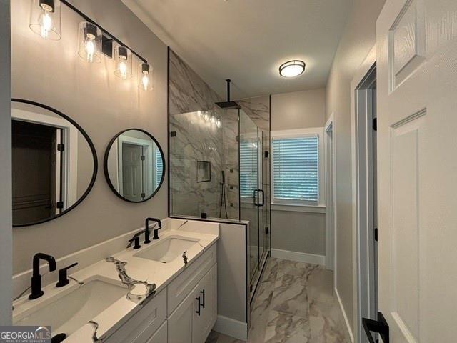 bathroom with vanity and a shower with shower door