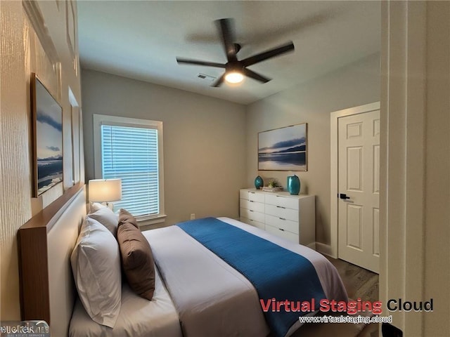 bedroom with ceiling fan and wood-type flooring