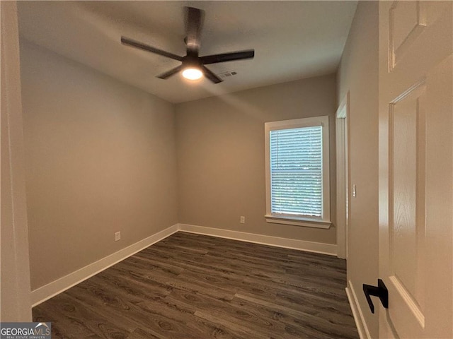 unfurnished room with dark hardwood / wood-style floors and ceiling fan