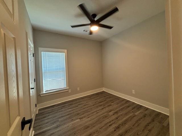 unfurnished room with dark hardwood / wood-style floors and ceiling fan