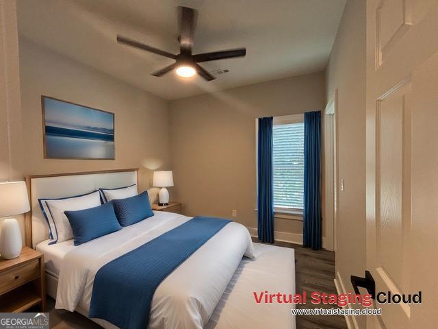 bedroom with ceiling fan and dark wood-type flooring