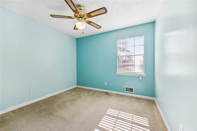 carpeted empty room with a textured ceiling and ceiling fan