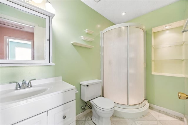 bathroom featuring vanity, toilet, and a shower with shower door