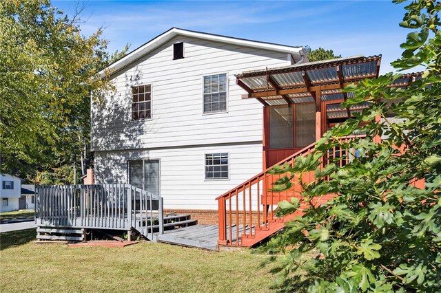 back of house with a deck, a yard, and a pergola