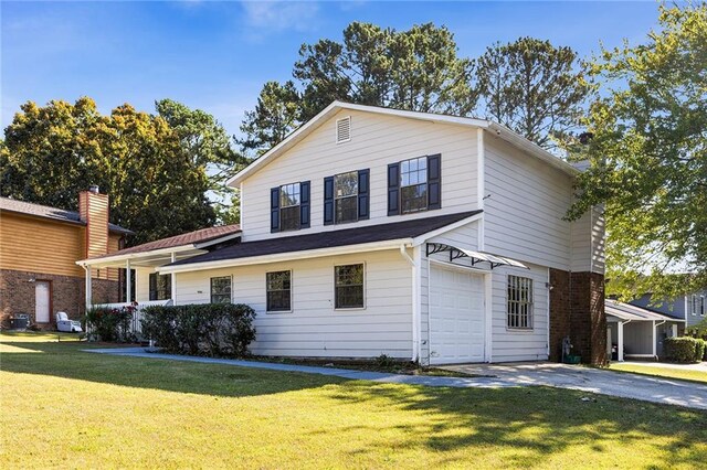 view of front of house with a front yard and a garage